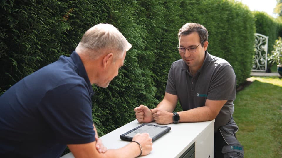 Tesisatçı ve Vaillant servis teknisyeni bir ısı pompası kuruyor.